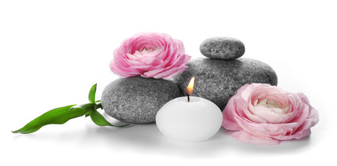 Fototapeta na wymiar Spa still life with pebbles, flowers and candle isolated on white