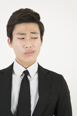 Stressed asian businessman in a black suit