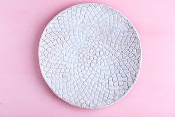 Empty plate on pink background