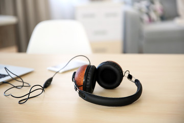 Obraz na płótnie Canvas Stylish headphones and gadgets on table
