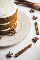 Cake with cream on the white wooden background. Shallow depth of field.