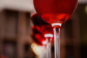 Many glasses of different wine in a row on bar counter