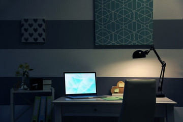 Stylish workplace with laptop at home