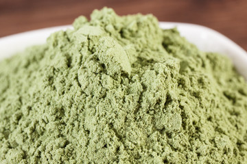 Closeup of young powder barley in dish, body detox