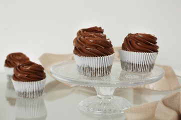 Chocolate cupcakes on light glass background