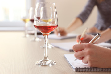 Experts tasting new sorts of wine at the table