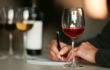 Man tasting new sorts of wine at the table