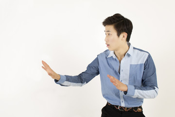 Side view portrait of serious young man showing stop or no gesture