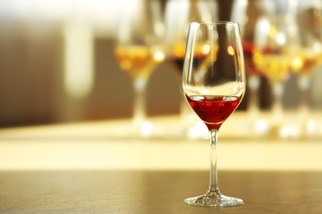 Glass of red wine on a table, close up