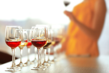 Many glasses of different wine in a row on a table. Tasting wine concept