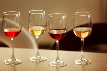 Many glasses of different wine in a row on a table