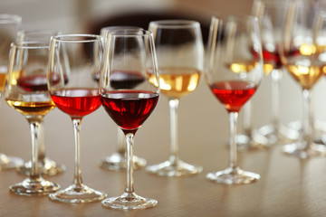 Many glasses of different wine on a table, close up