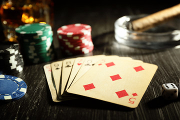 Set to playing poker with cards and chips on wooden background