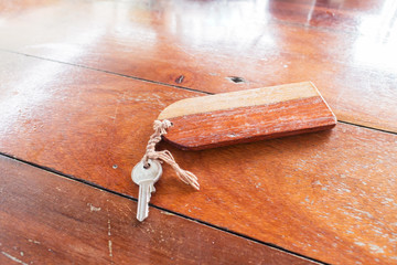 Blank wood tag and keys on wooden table, selective focus