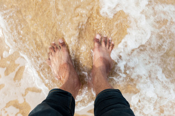 Foot in the water of the sea