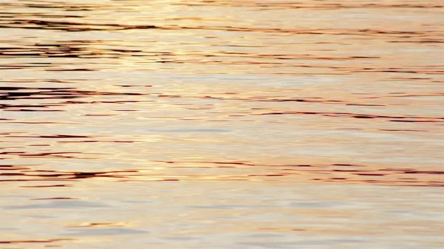 bright water rippling on the surface of a northern lake at sunset