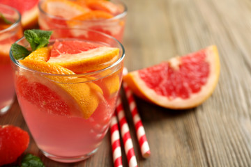 Ripe grapefruits and fresh juice with mint, close up