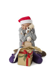 happy elementary girl hugging her teddy bear.