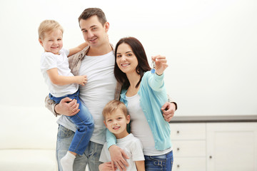 Fototapeta na wymiar Happy family with key in new house, indoor