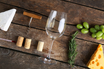Wine, snacks and different various of cheese, flat lay