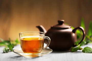 Cup of tea and teapot on table