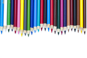 colored pencil arranged side by side over white.