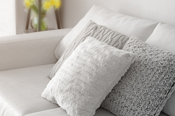 Fototapeta na wymiar Stylish pillows on grey couch
