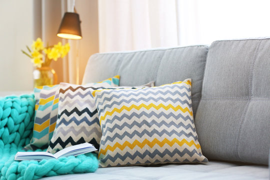 Stylish Pillows On Grey Couch In Room Interior