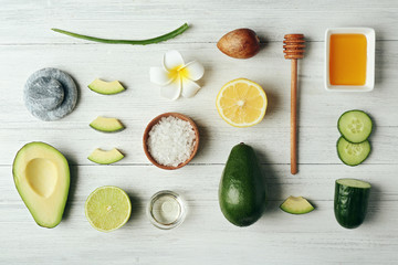 Still life with avocado oil on wooden table, top view