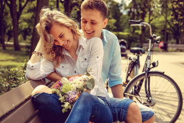 Happy man and cute blond woman with flowers.