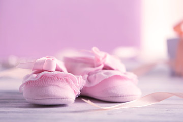 Plakat Beautiful composition with baby booties on wooden background