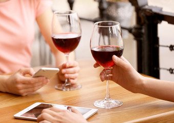 Young women drinking wine in cafe