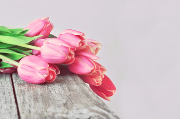 Bouquet of pink tulips on the table.