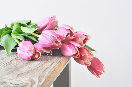 Bouquet of pink tulips on the table.