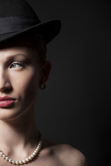 Portrait of a beautiful young model in black hat