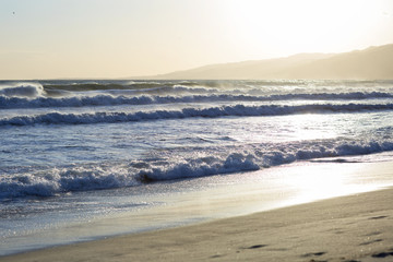 Fototapeta premium The Pacific ocean during sunset. Landscape with blue sea, the mountains and the dusk sky, the USA, Santa Monica. 