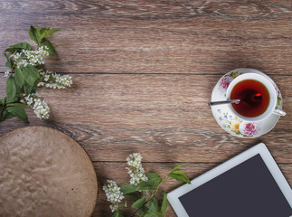 cup of tea and computer on the dining table