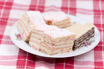 Cake with cookies and strawberries served on a plate