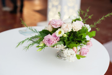 bouquet of flowers in vase at the wedding table