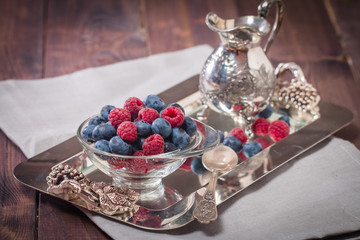 cream with raspberries and blueberries