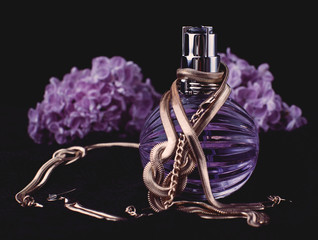 Women's perfume and purple flowers