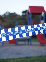 Blue and white Police tape cordoning off an colorful playground area like a crime scene , Australia 2016 - 111372769