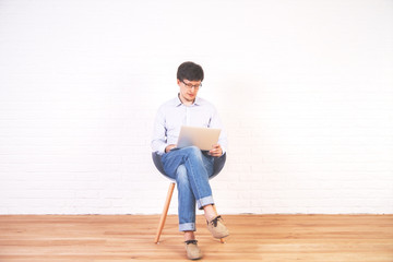 Man using laptop brick interior