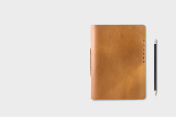 Brown Leather notebooks with pencil on gray table background