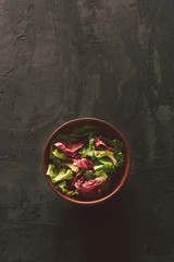 Obraz na płótnie Canvas Fresh salad on a dark surface