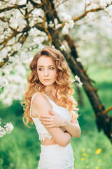 Naklejka premium Beautiful woman in blooming garden