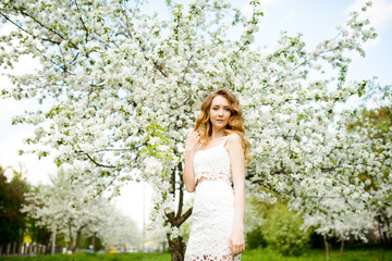 Beautiful woman in blooming garden
