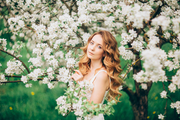 Beautiful woman in blooming garden