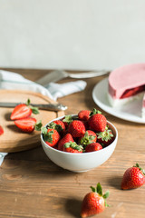 ripe strawberries on plate on wooden background