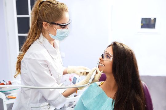 Overview of dental caries prevention.Woman at the dentist's chair during a dental procedure. Beautiful Woman smile close up. Healthy Smile. Beautiful Female Smile


